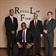 Group of men in suits posing for business photo